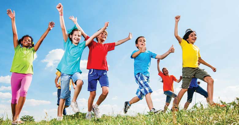 smiling children running across a field